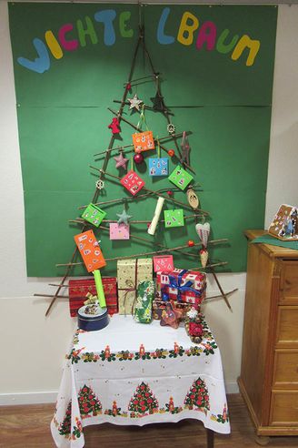 Wichtelbaum aus Zweigen mit bunten Karten und Geschenken